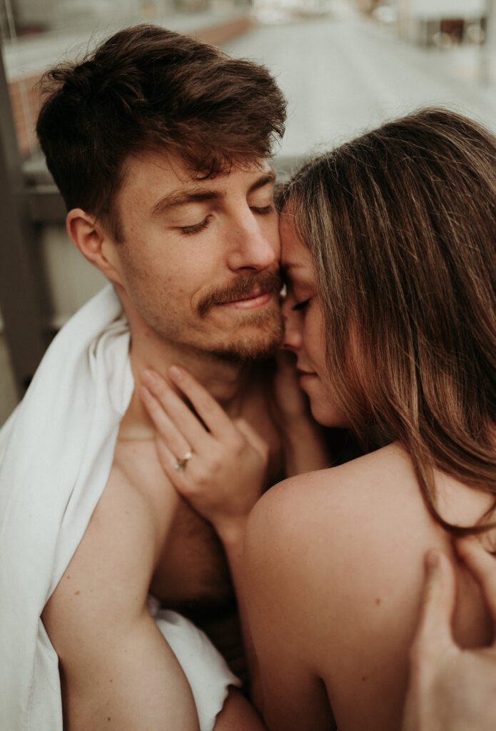 couple posing for their cozy engagement photos | At Home Engagement Photos