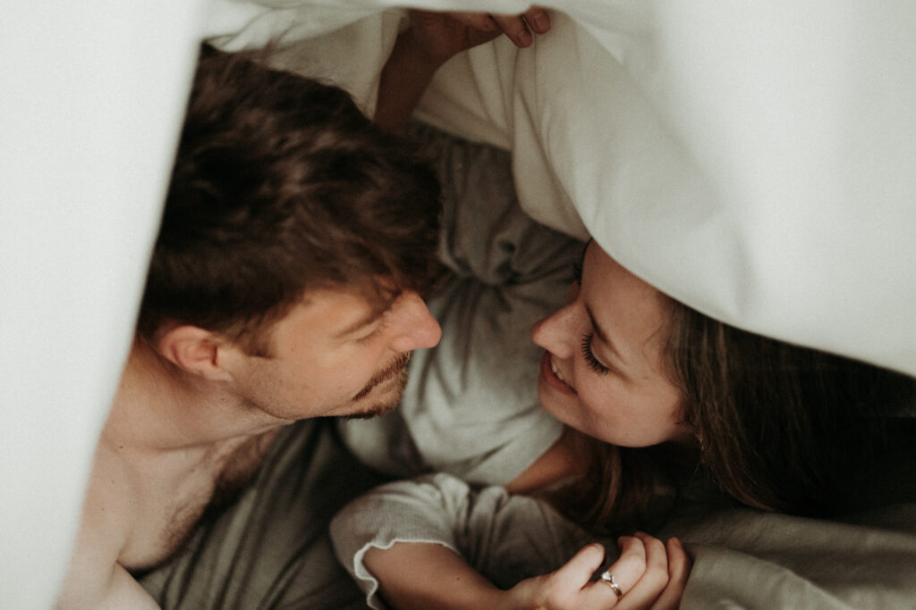 couple posing for their cozy engagement photos | At Home Engagement Photos