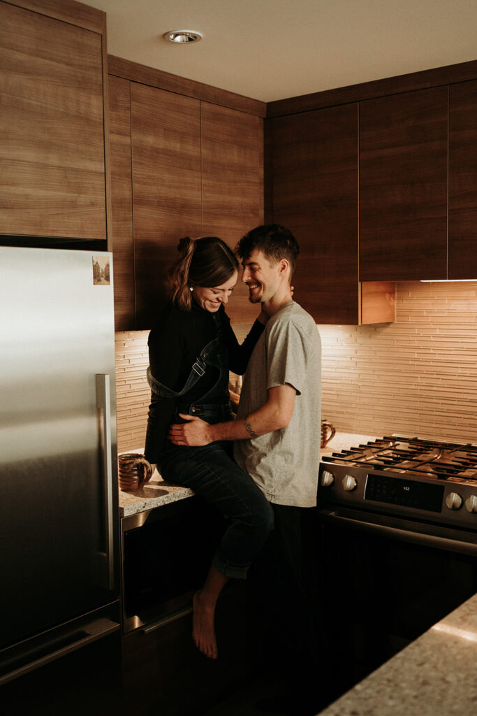 couple posing for their cozy engagement photos | At Home Engagement Photos
