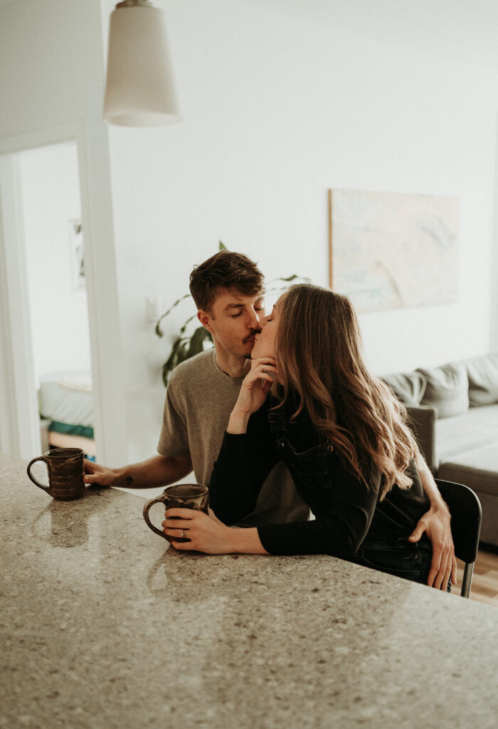 couple posing for their cozy engagement photos | At Home Engagement Photos
