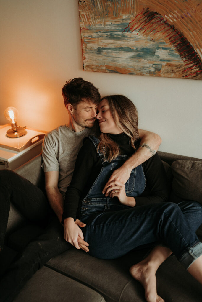 couple posing for their cozy engagement photos | At Home Engagement Photos