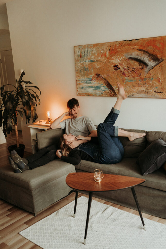 couple posing for their cozy engagement photos | At Home Engagement Photos
